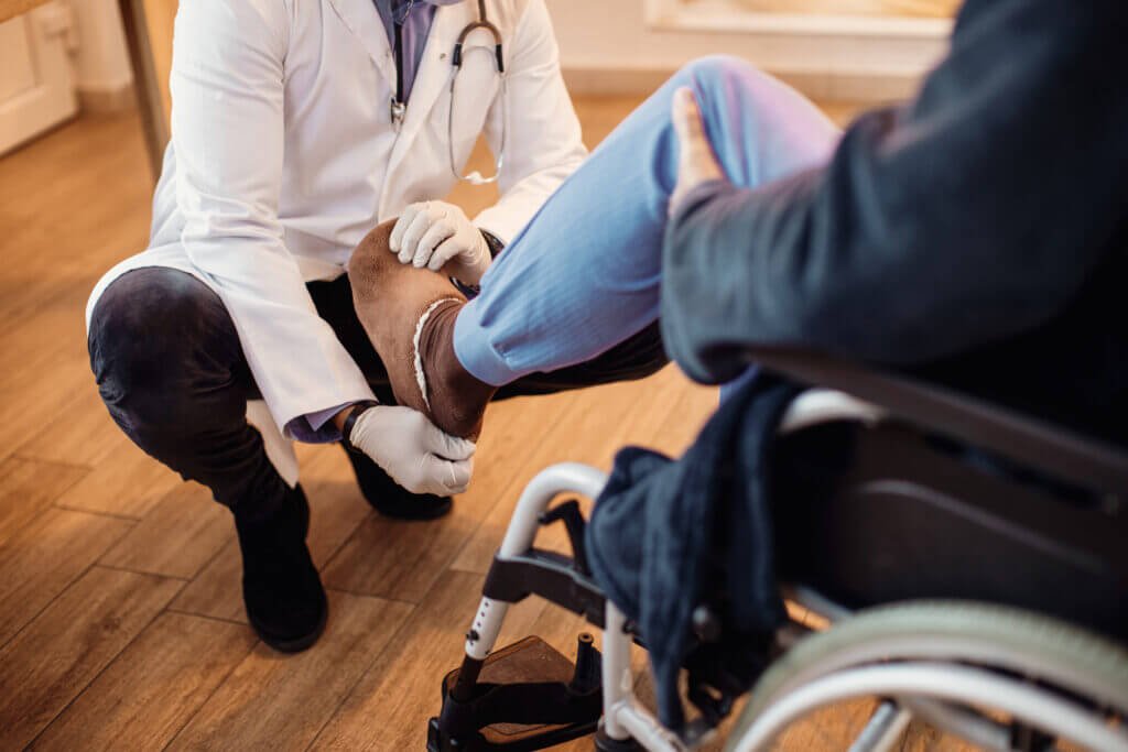 foot care by a professional nurse - unrecognizable doctor examining leg senior patient nursing home 1 1024x683 - The Best Foot Care by a Professional Nurse